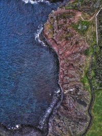 High angle view of rocks by sea