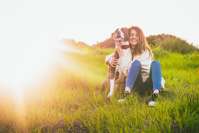 Woman with dog on field