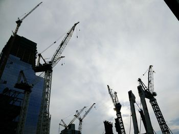 Low angle view of crane against sky