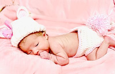 Close-up of baby sleeping on bed