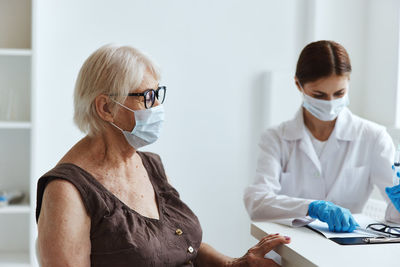 Woman in front of two people