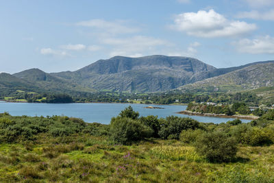 Scenic view of lake and mountains against sky