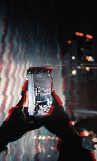 Man photographing illuminated at music concert