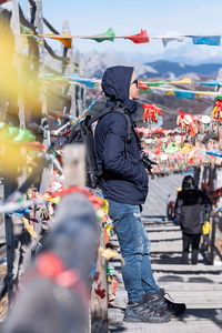 Rear view of people standing in city