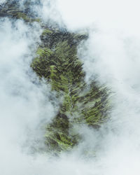 Scenic view of waterfall against sky