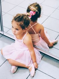 High angle view of ballet dancer sitting on floor by mirror