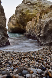 Rocks on beach against sky