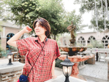 Man looking away while standing outdoors