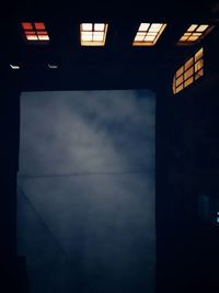 Low angle view of illuminated building against sky at dusk