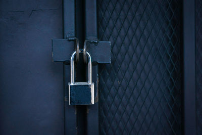 Close-up of padlock on metal gate