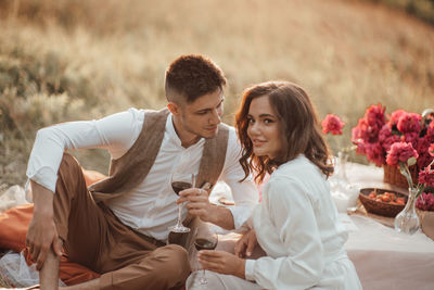 Young couple sitting on top of people