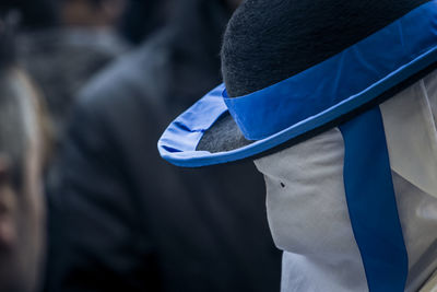 Rear view of person standing against blue wall