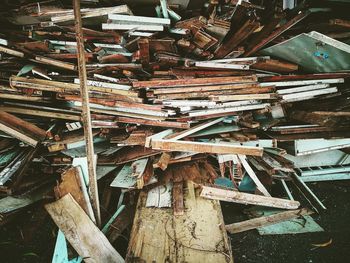 Stacked abandoned wooden furniture at junkyard