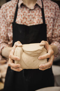 Midsection of woman making wedding dress