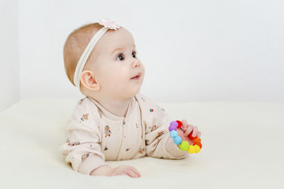 Portrait of cute baby girl sitting on table