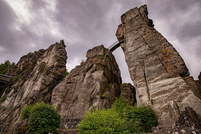 Low angle view of rock formation against sky