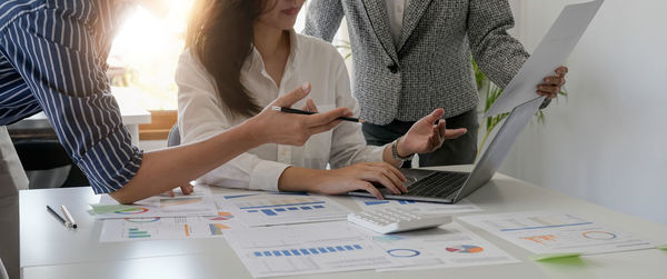 Midsection of business colleagues working at office