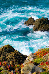 High angle view of rocks at sea shore