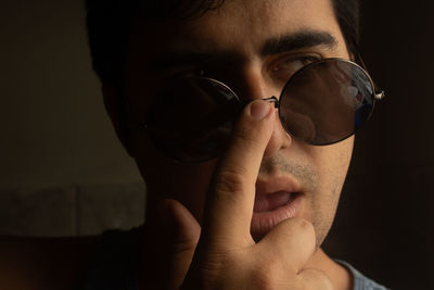 Close-up portrait of young man wearing sunglasses