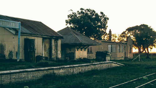 Abandoned house on field against clear sky