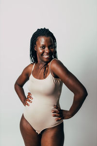 Portrait of smiling woman against white background