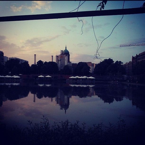 reflection, water, architecture, built structure, building exterior, sky, lake, waterfront, sunset, standing water, cloud - sky, silhouette, river, cloud, tranquility, dusk, tranquil scene, tree, scenics, nature