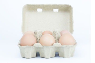 Close-up of ice cream in box against white background