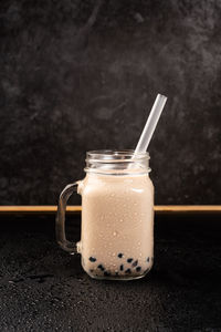 Close-up of drink in glass jar on table