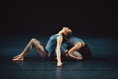 Young couple sitting on floor