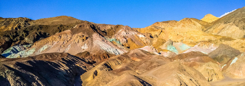 Panoramic view of mountains against clear blue sky