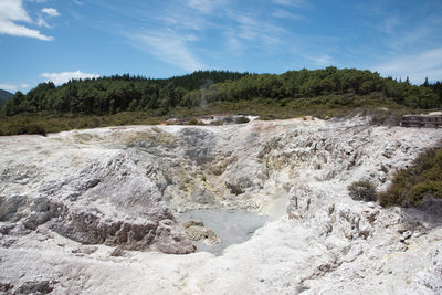 Scenic view of waterfall against sky