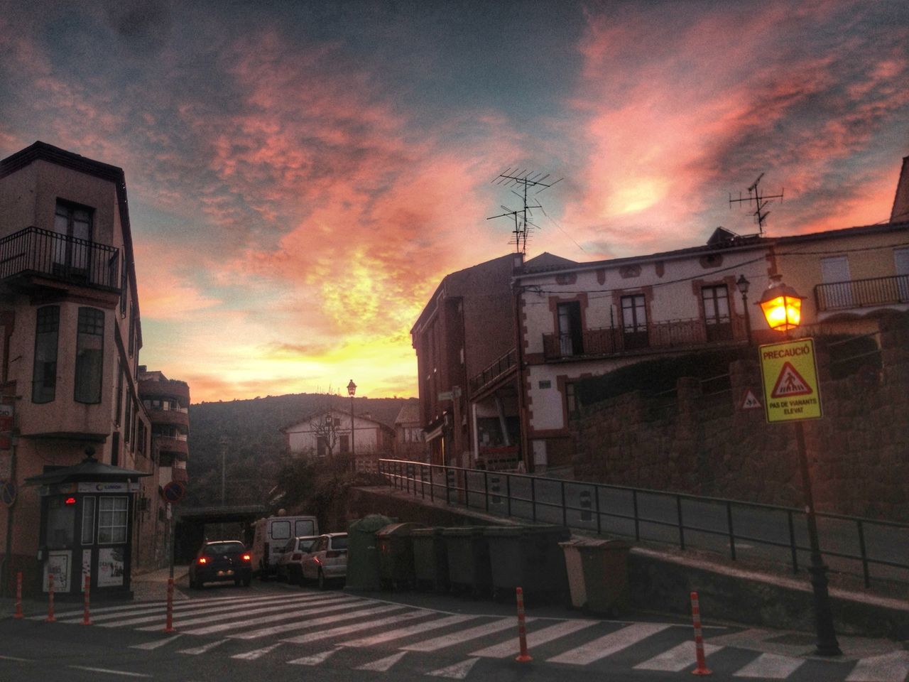 sky, architecture, building exterior, built structure, cloud - sky, sunset, cloudy, illuminated, street light, weather, transportation, street, dusk, city, residential building, orange color, dramatic sky, overcast, cloud, residential structure