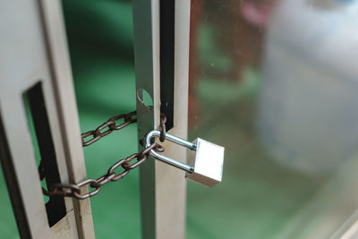 Close-up of padlock on glass door