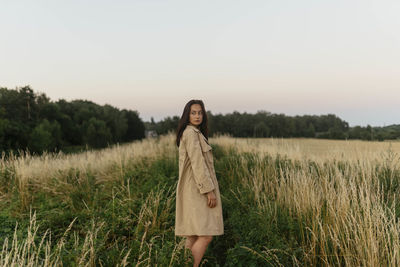 Woman in a meadow in a raincoat