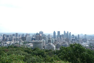 Buildings in city against clear sky