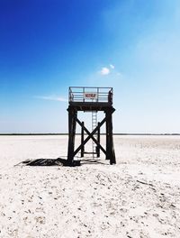 Lifeguard hut on beach against sky