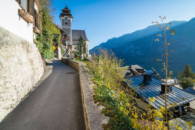 Road amidst buildings against sky