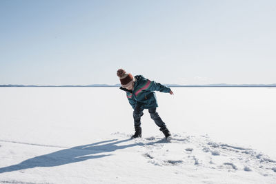 Girl walking on an icy lake in sweden