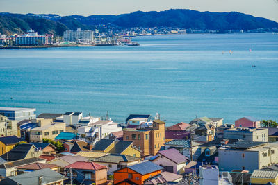 High angle view of townscape by sea