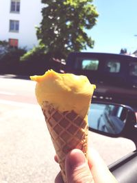 Close-up of hand holding ice cream cone