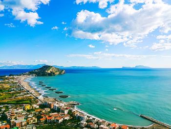 High angle view of townscape by sea against sky