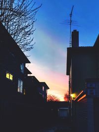 Low angle view of silhouette buildings against sky at sunset