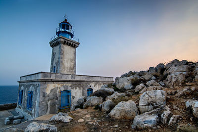 Lighthouse tenaron against sky during blue hour