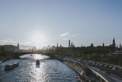 Bridge over river in city against sky