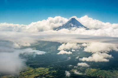 Scenic view of clouds over mountains against sky