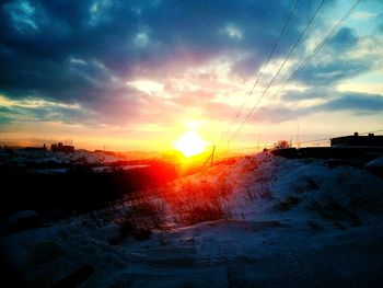 Scenic view of snow covered landscape at sunset