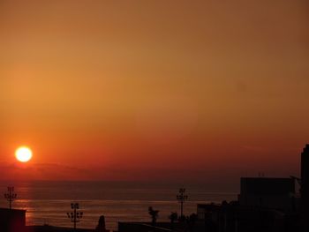 Scenic view of sea against orange sky