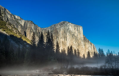 Scenic view of mountains against clear blue sky