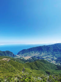 Scenic view of landscape against blue sky