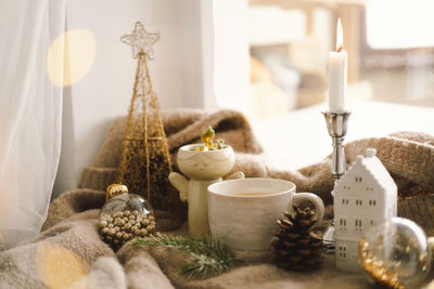 Hot tea, candles, christmas golden balls and decorations. christmas holiday mood